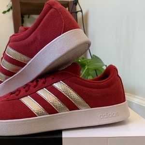 Red adidas sneakers with silver stripes